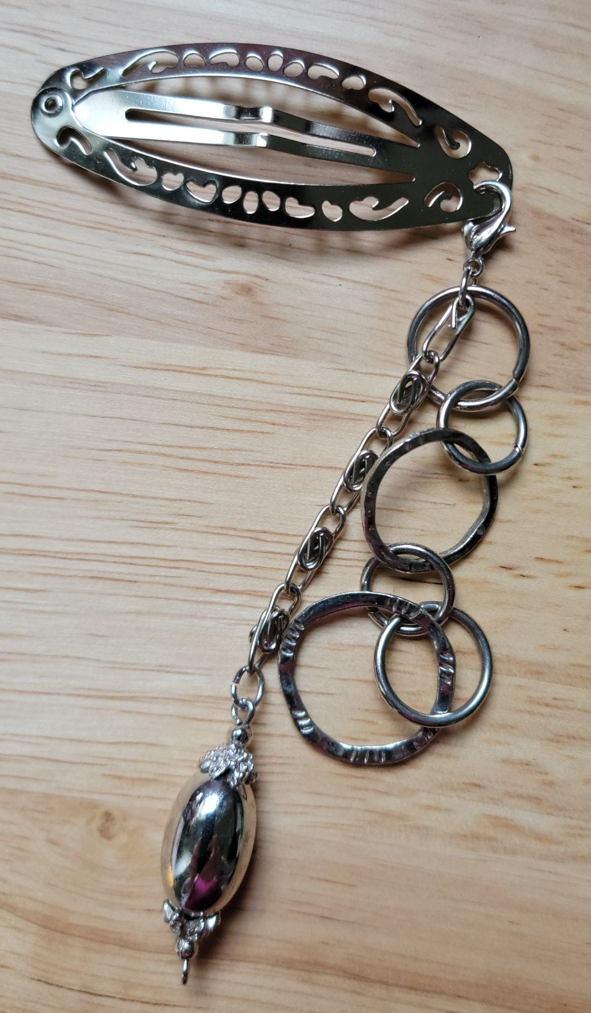 Handmade silver filigree hair clip with cascading chain rings and silver locket bead pendant