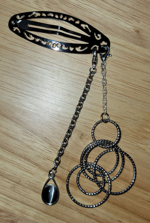 Handmade black filigree hair clip with dual chain drop, interlocking beaded rings and black teardrop stone pendant