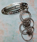 Handmade silver filigree hair clip with interlocking beaded rings and two silver butterfly charms