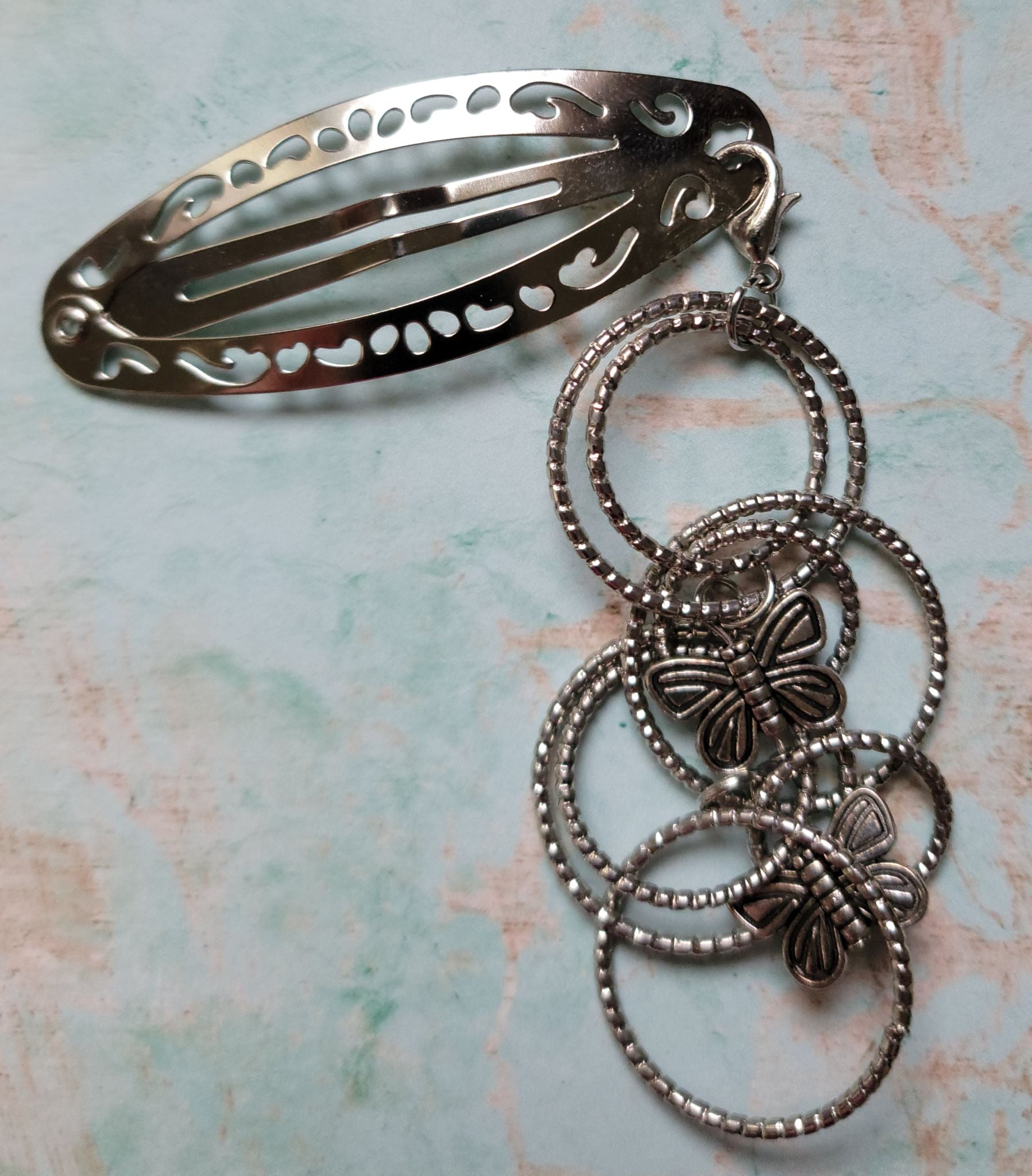 Handmade silver filigree hair clip with interlocking beaded rings and two silver butterfly charms